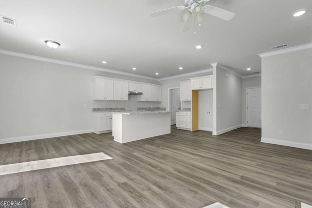 kitchen featuring white cabinetry, ceiling fan, a kitchen island, and hardwood / wood-style flooring