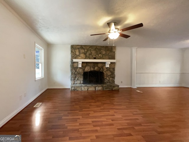 unfurnished living room with ceiling fan, a fireplace, hardwood / wood-style floors, and a textured ceiling