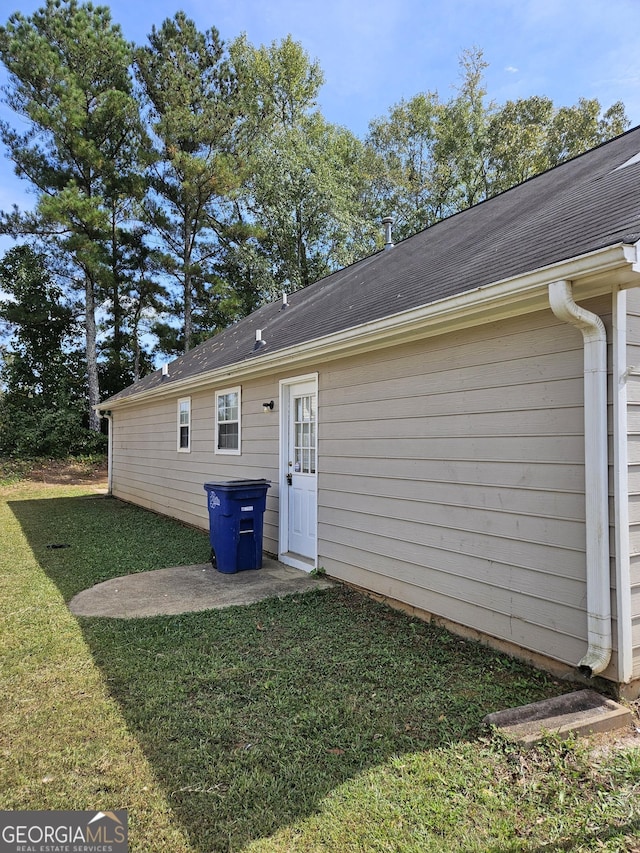 back of property featuring a yard and a patio area