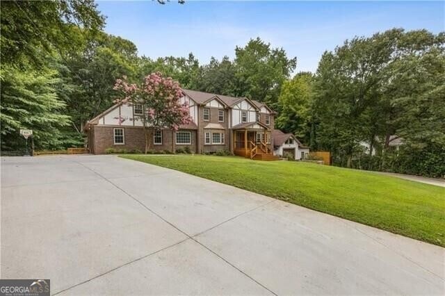 english style home featuring a front lawn