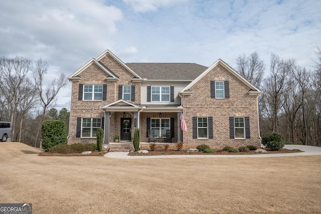 craftsman house with a porch and a front yard