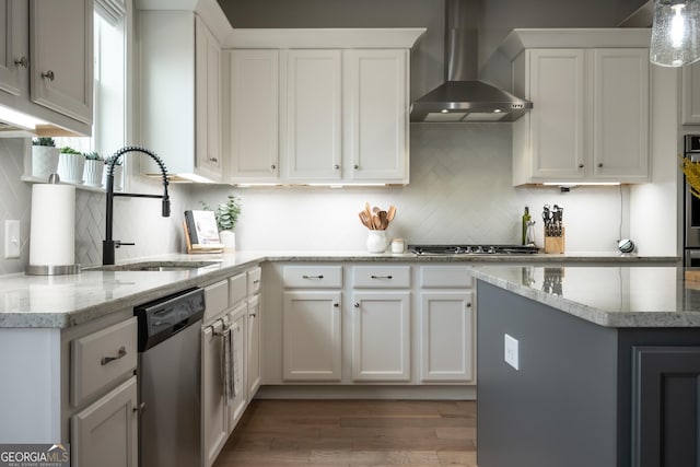 kitchen featuring sink, stainless steel appliances, dark hardwood / wood-style floors, white cabinets, and wall chimney exhaust hood