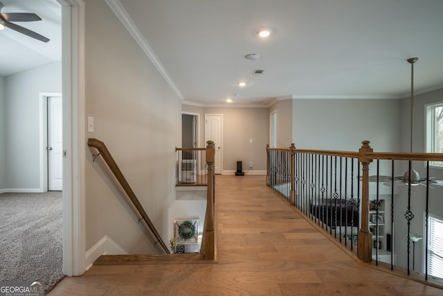 hall with crown molding and light wood-type flooring