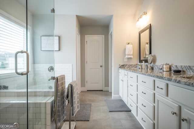 bathroom featuring tile patterned flooring, vanity, and a shower with shower door