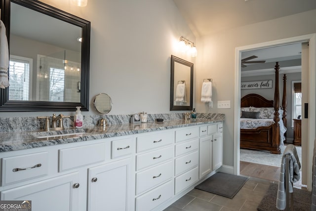 bathroom featuring vanity, plenty of natural light, and lofted ceiling