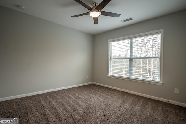 carpeted empty room featuring ceiling fan