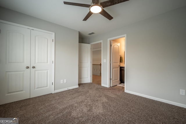 unfurnished bedroom featuring ceiling fan, a closet, ensuite bath, and carpet