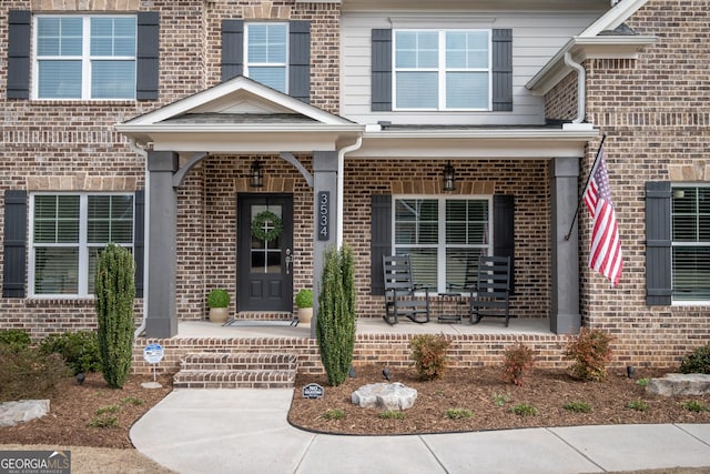 view of exterior entry with covered porch