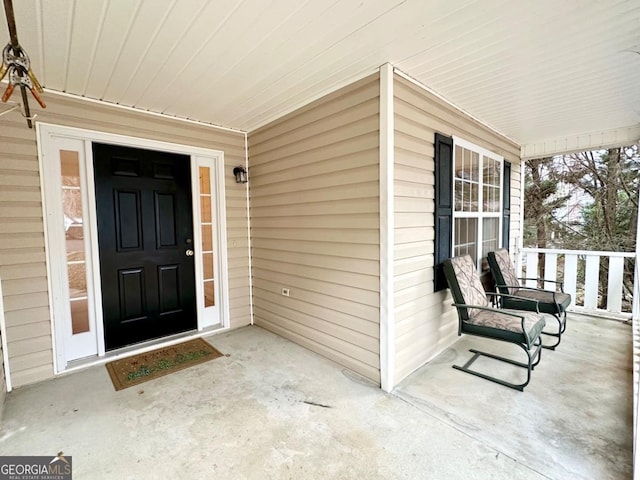 view of exterior entry with a porch