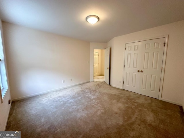 unfurnished bedroom featuring a closet and carpet