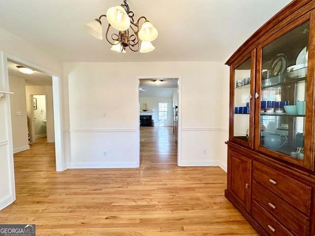 dining space with a chandelier and light hardwood / wood-style flooring