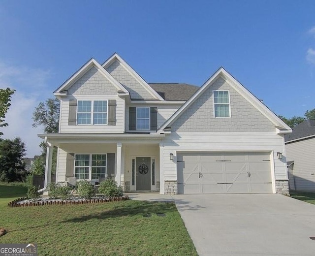 craftsman inspired home with a porch, a garage, and a front lawn