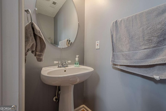 bathroom with a textured ceiling