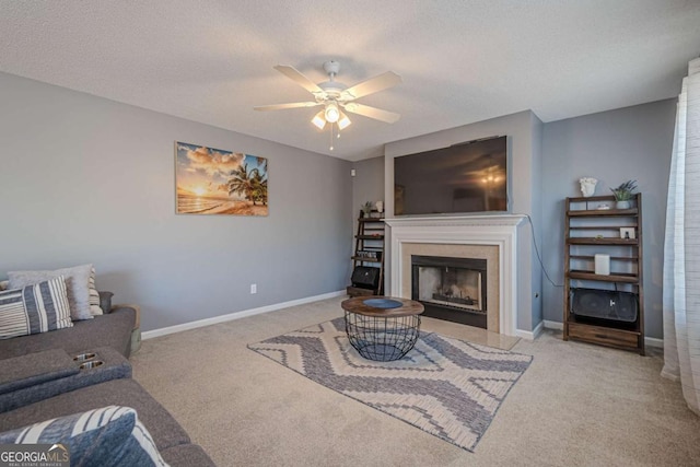 carpeted living room with a textured ceiling and ceiling fan