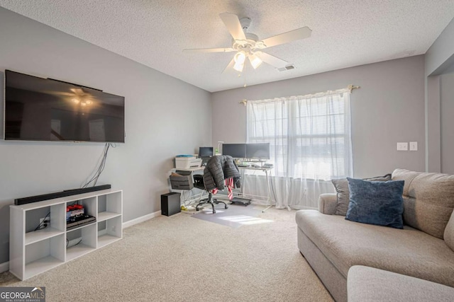 carpeted office with ceiling fan and a textured ceiling