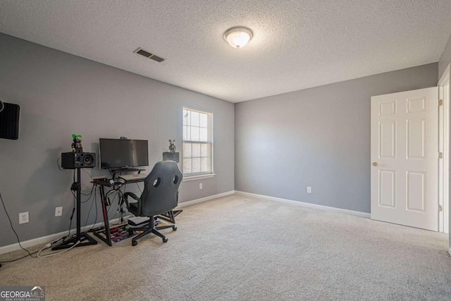 office area with carpet floors and a textured ceiling