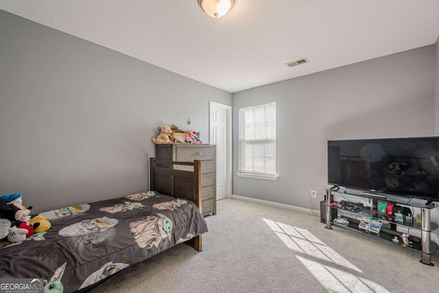 carpeted bedroom featuring a textured ceiling