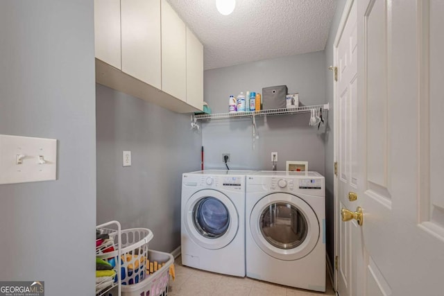 laundry area with separate washer and dryer, light tile patterned floors, cabinets, and a textured ceiling