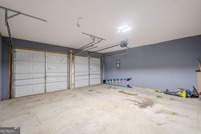 garage with a garage door opener and electric panel