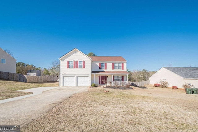 view of front of house with a porch, a garage, and a front lawn