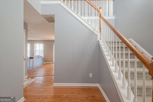 staircase featuring hardwood / wood-style flooring