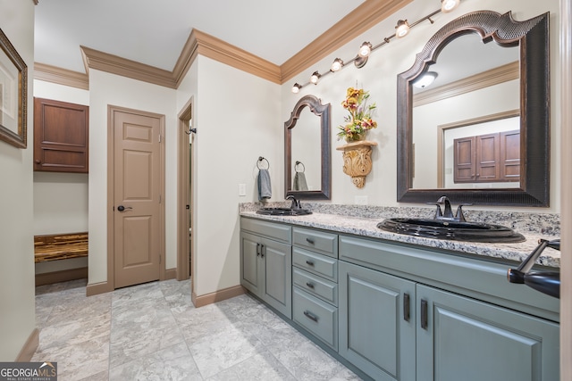 full bathroom with double vanity, a sink, baseboards, and crown molding