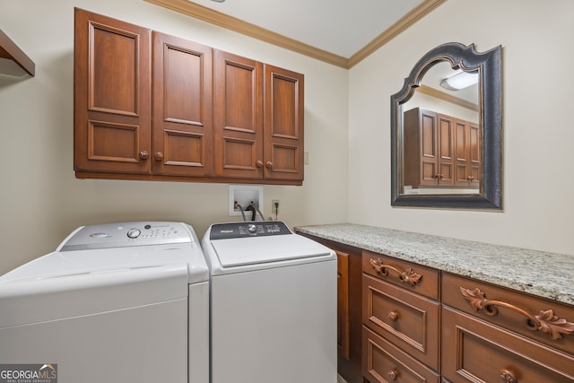 washroom featuring cabinets, ornamental molding, and washer and clothes dryer