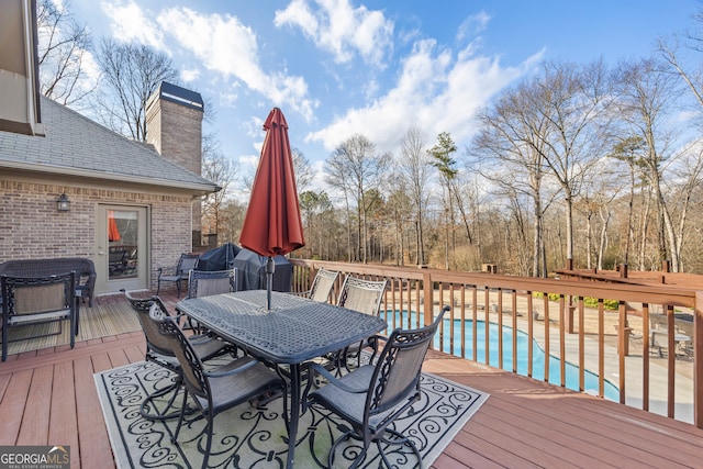 deck featuring a fenced in pool