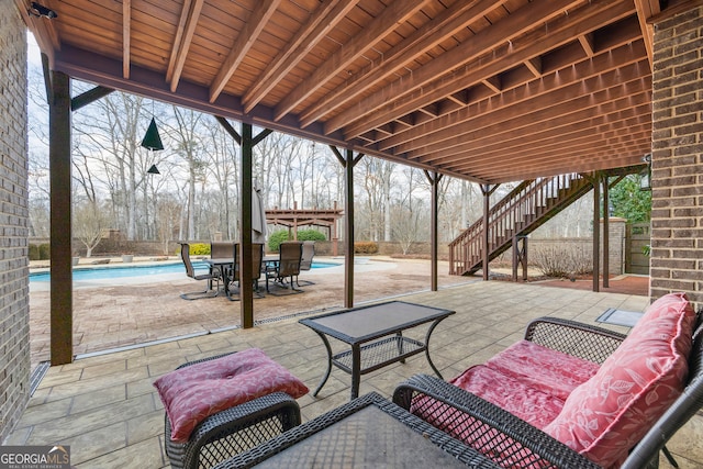 view of patio / terrace with an outdoor hangout area, stairway, and an outdoor pool