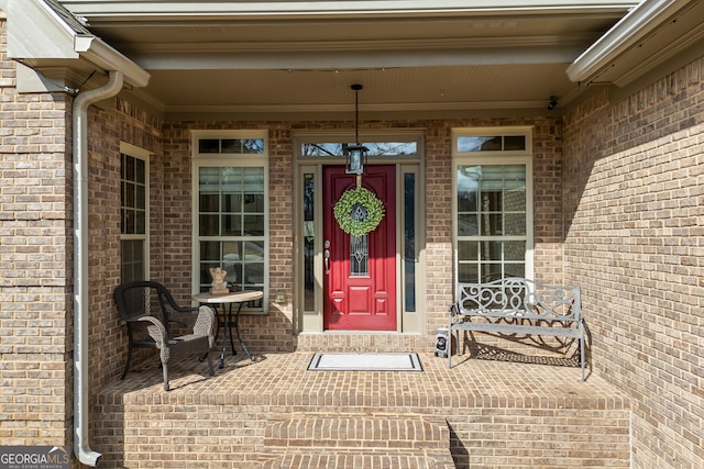 doorway to property with brick siding