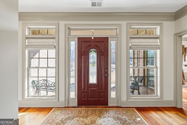 foyer featuring light wood-type flooring and visible vents