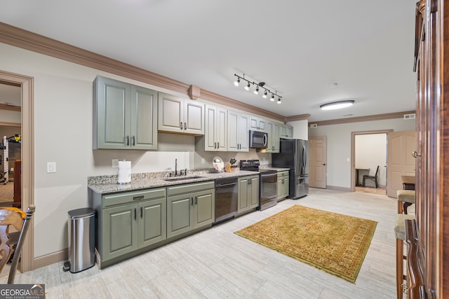 kitchen with light stone counters, ornamental molding, stainless steel appliances, and sink