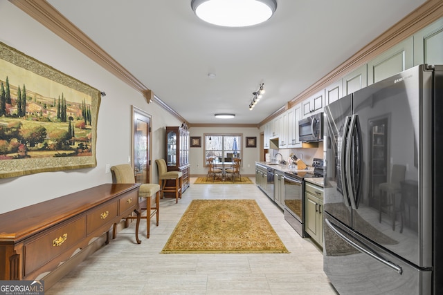 kitchen with crown molding, stainless steel microwave, black range with electric stovetop, freestanding refrigerator, and a sink