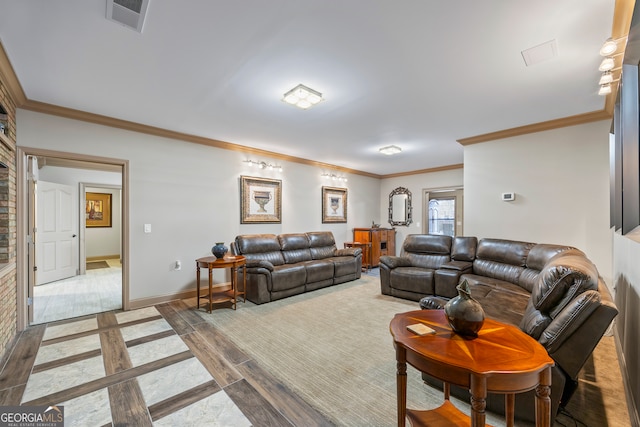 living area with crown molding, wood finished floors, visible vents, and baseboards
