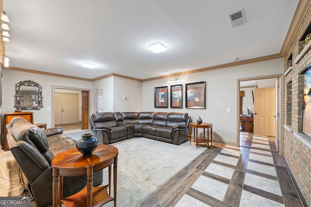 living room featuring baseboards, visible vents, and crown molding