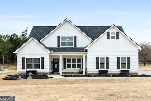 modern farmhouse featuring roof with shingles and board and batten siding