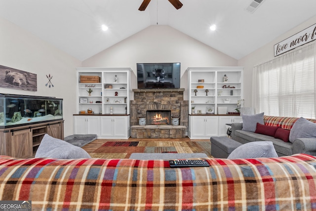 living room with a fireplace, lofted ceiling, visible vents, a ceiling fan, and wood finished floors