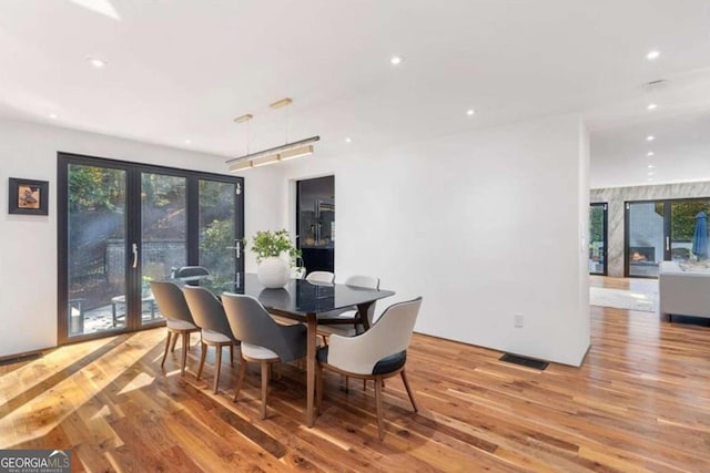 dining area featuring light hardwood / wood-style flooring and french doors