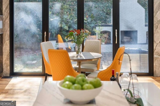 dining area with hardwood / wood-style flooring and expansive windows