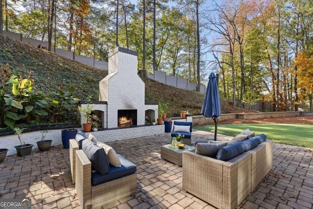 view of patio / terrace with an outdoor living space with a fireplace