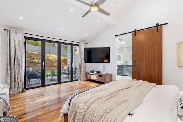 bedroom with connected bathroom, access to exterior, vaulted ceiling with beams, light wood-type flooring, and a barn door