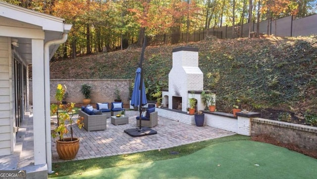 view of patio with an outdoor living space with a fireplace