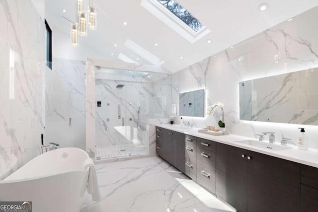 bathroom with vanity, vaulted ceiling with skylight, tile walls, and separate shower and tub