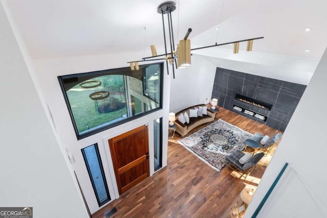living room with dark wood-type flooring and a tile fireplace