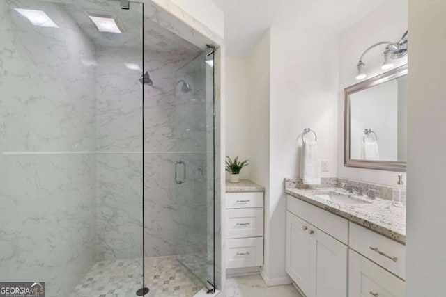 bathroom featuring walk in shower and vanity