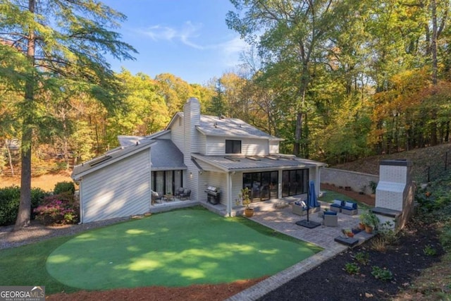 back of house with a patio and outdoor lounge area