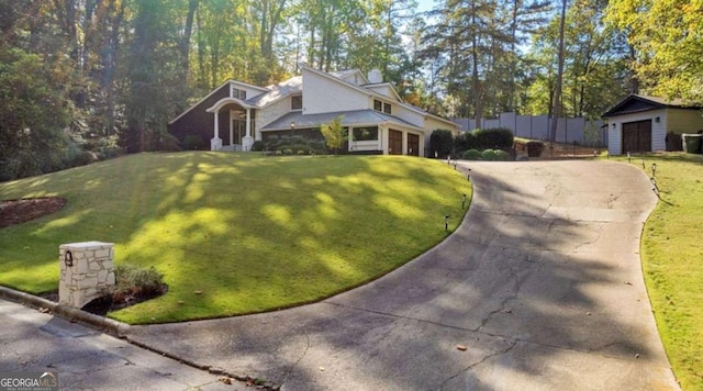 view of front of home with a garage and a front lawn