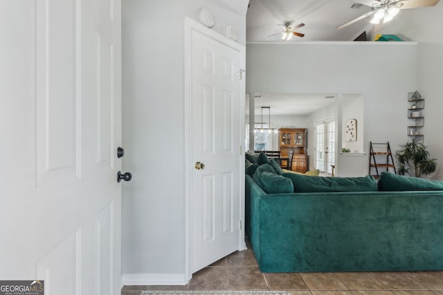 tiled living room with ceiling fan