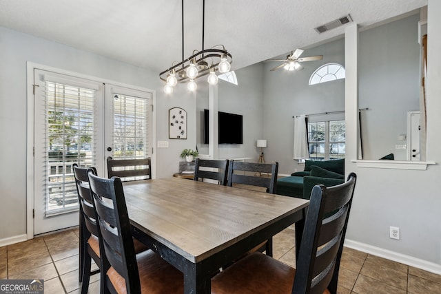 dining room with french doors, tile patterned floors, and a wealth of natural light