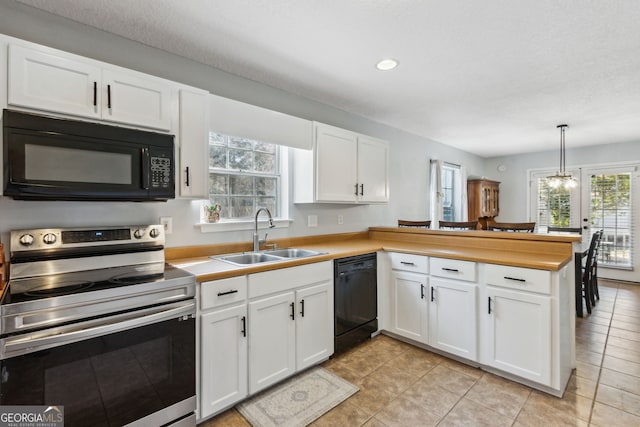 kitchen featuring sink, white cabinetry, black appliances, decorative light fixtures, and kitchen peninsula